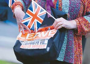 A vote leave supporter holds a poster in Westminster, London