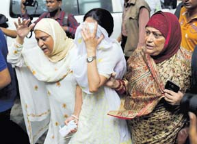 People react near the Holey Artisan restaurant after Islamist militants attacked the upscale cafe in Dhaka