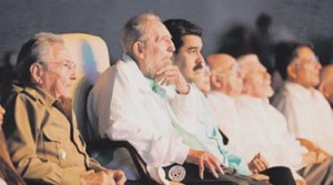Cuba's former president Fidel Castro sits next to Cuba's President Raul Castro and Venezuela's President Nicolas Maduro during a cultural gala to celebrate Fidel's 90th birthday in Havana