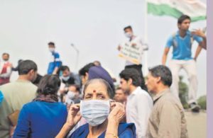 A woman wears a mask to protect herself from the pollution during a protest in Delhi